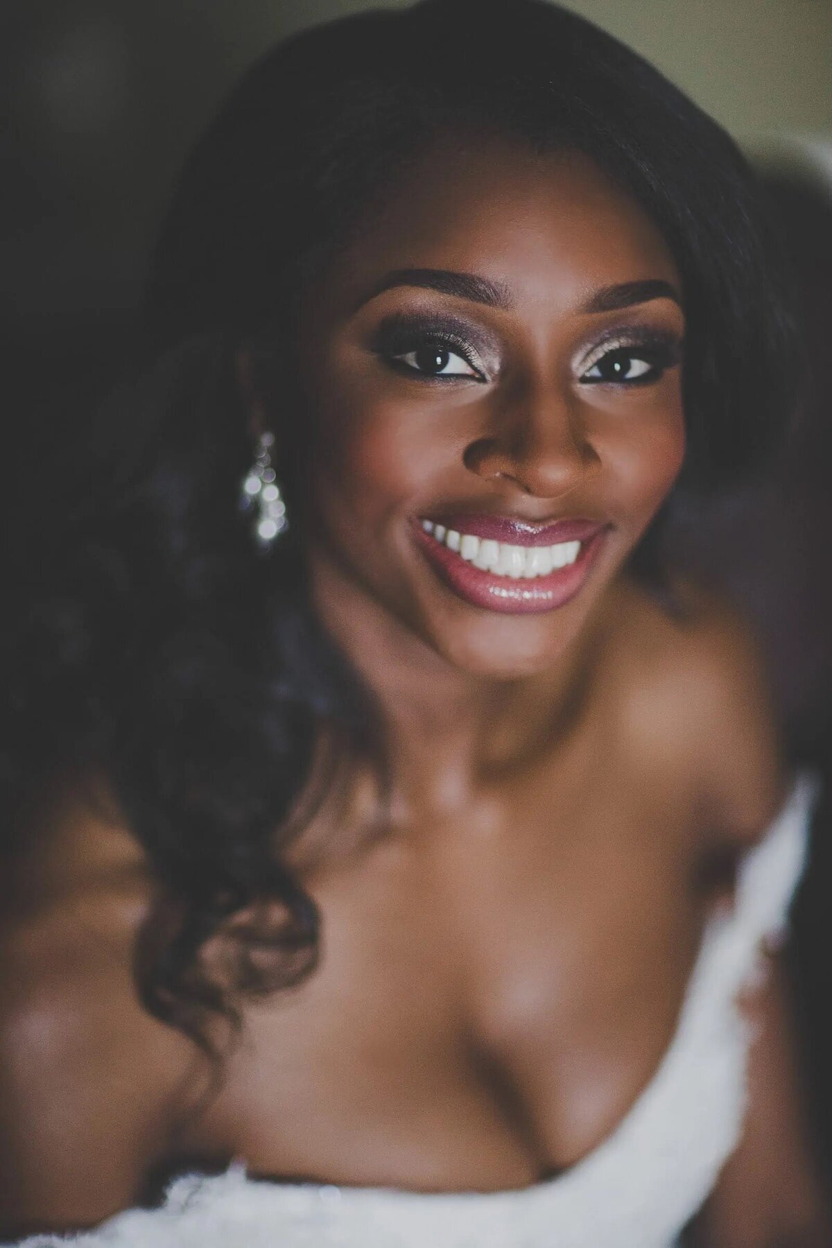 A bride sitting down and smiling