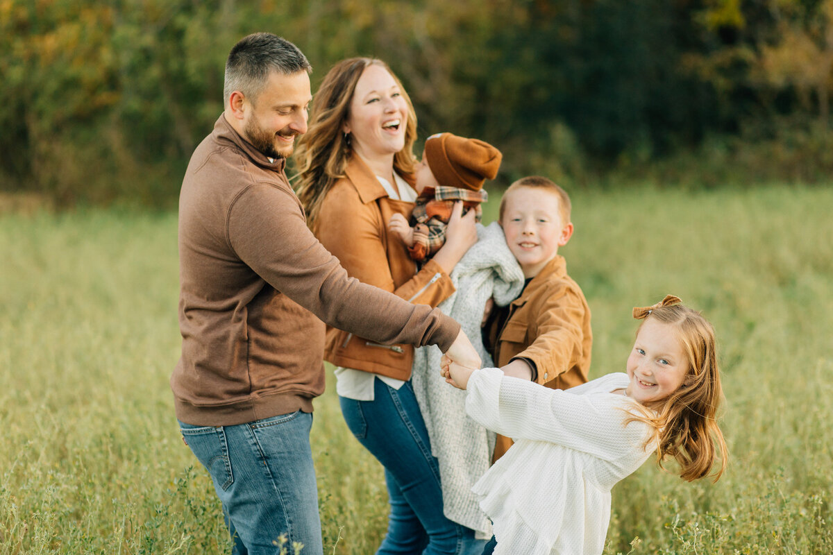 Family of four playing outside.