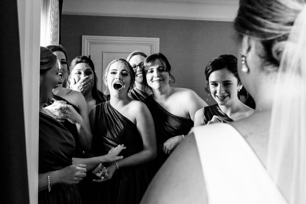 Black-and-white-reaction-image-during-bridesmaids-first-look-at-The-Ballantyne