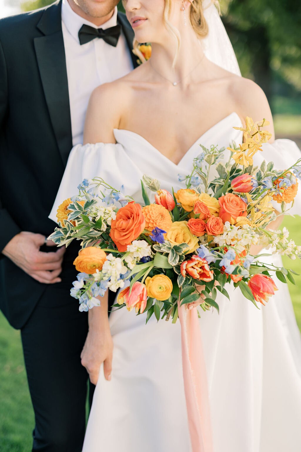 wedding bouquet with orange, yellow and blue flowers