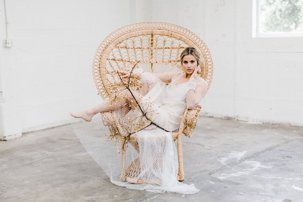 Model lying in cane chair with natual makeup