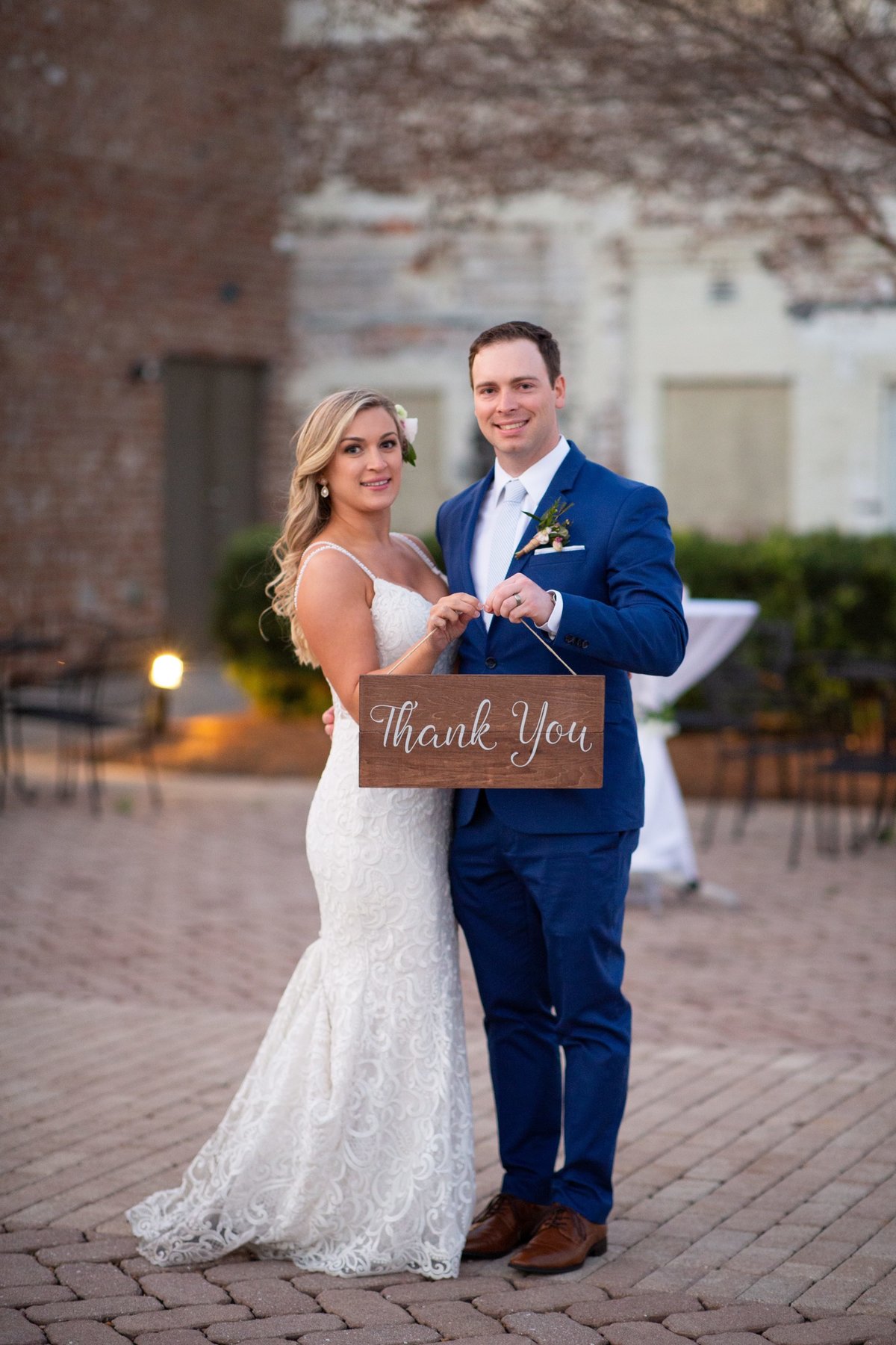 bride and groom holding sign