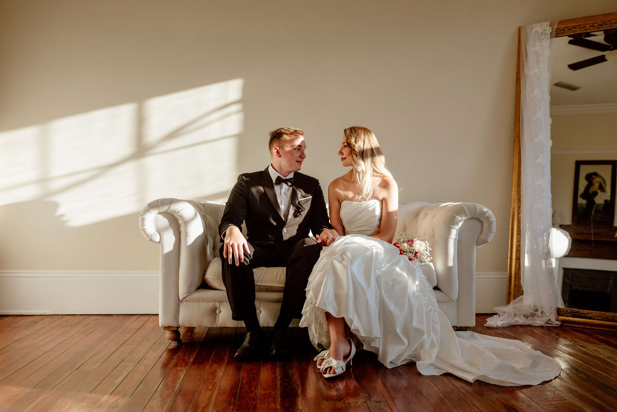 bride & groom enjoy moment together in private room of panama city wedding venue The Sapp House