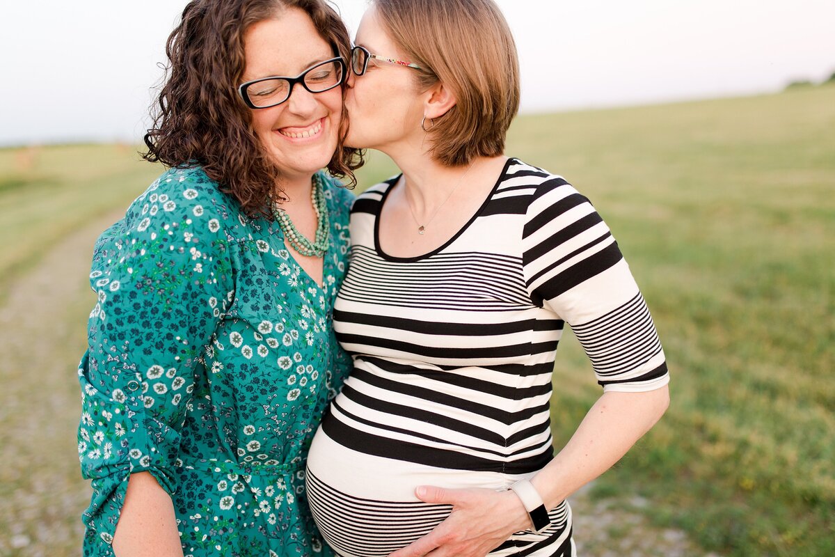A beautiful LGBTQ+ maternity session of two moms with their heads together at Talon Winery in Lexington KY.