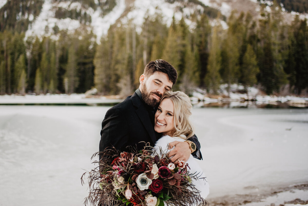 Jackson Hole Photographers capture bride and groom hugging after winter elopement