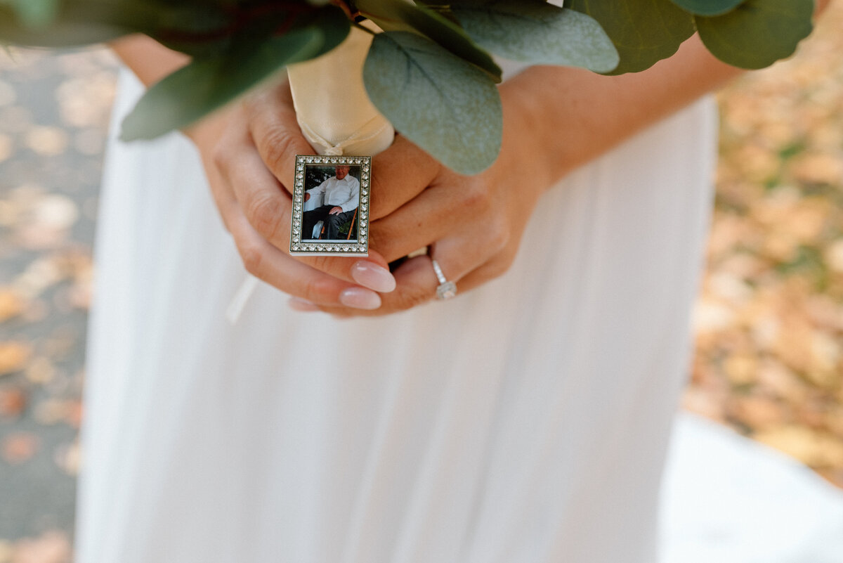 bride's locket with photo of her grandfather on her bouquet