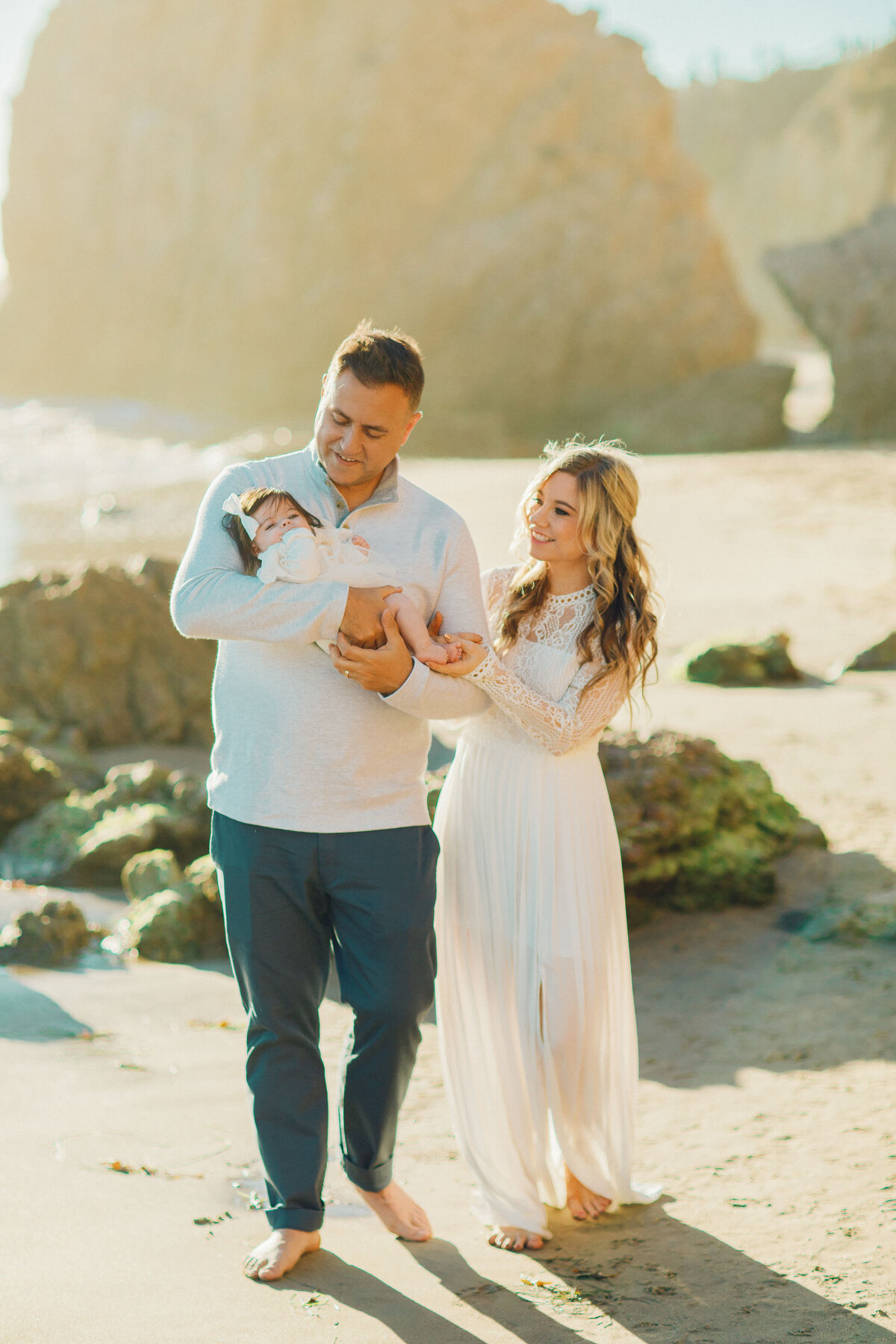 Family Portrait Photo Of Couple Walking With Their Baby In The Sun Los Angeles