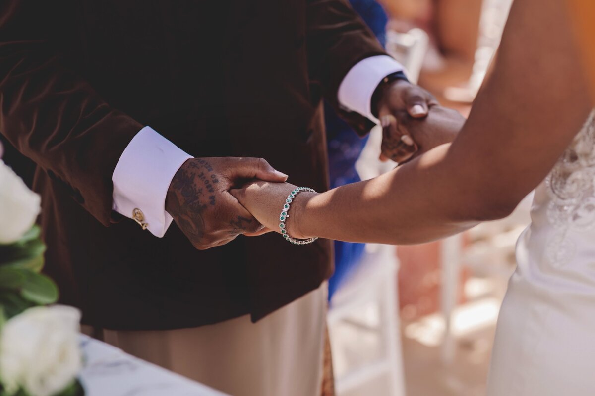Close up of bride and groom holding hands at Cancun wedding ceremony
