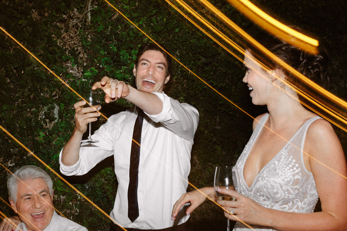 man toasting smiling at Italian wedding reception