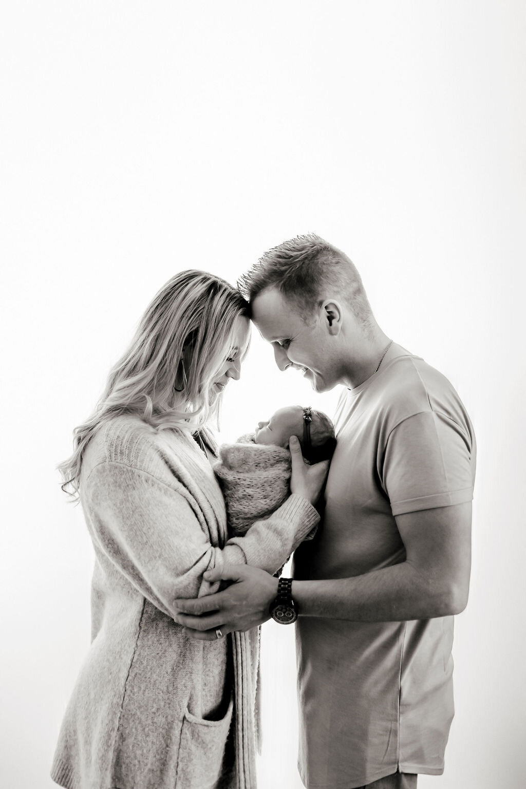 parents holding their baby girl for photos in our loveland studio