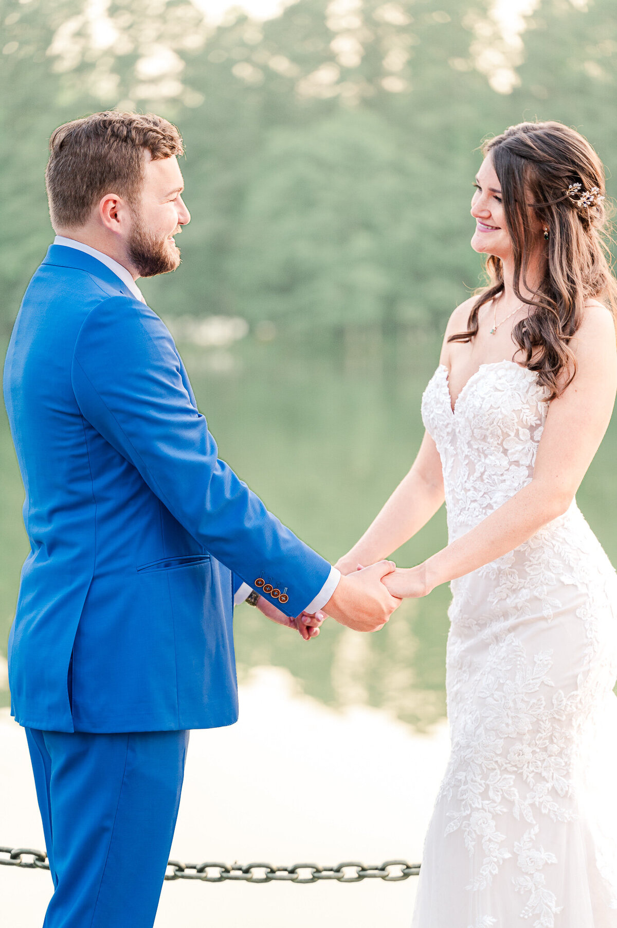 A bride and groom holding hands at sunset at the Pavilion at the Angus Barn by JoLynn Photography, a North Carolina wedding photographer