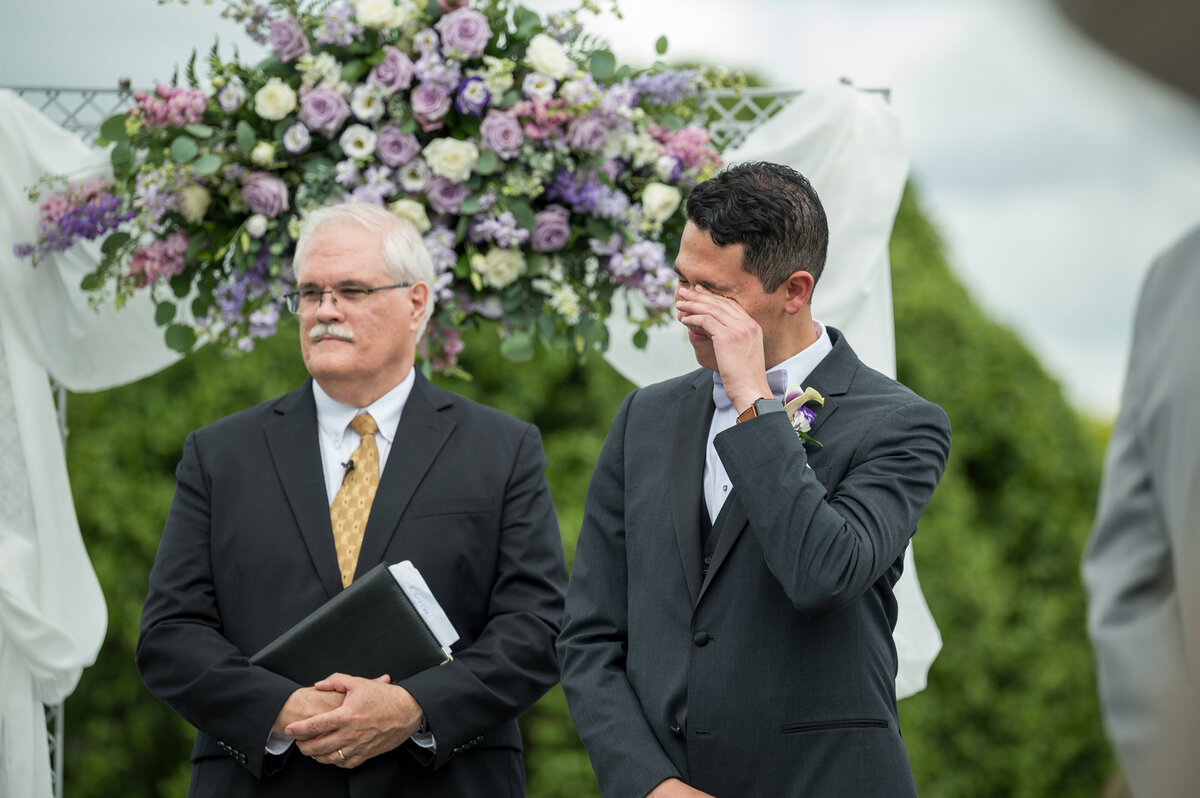 Groom crying when he sees bride during ceremony.