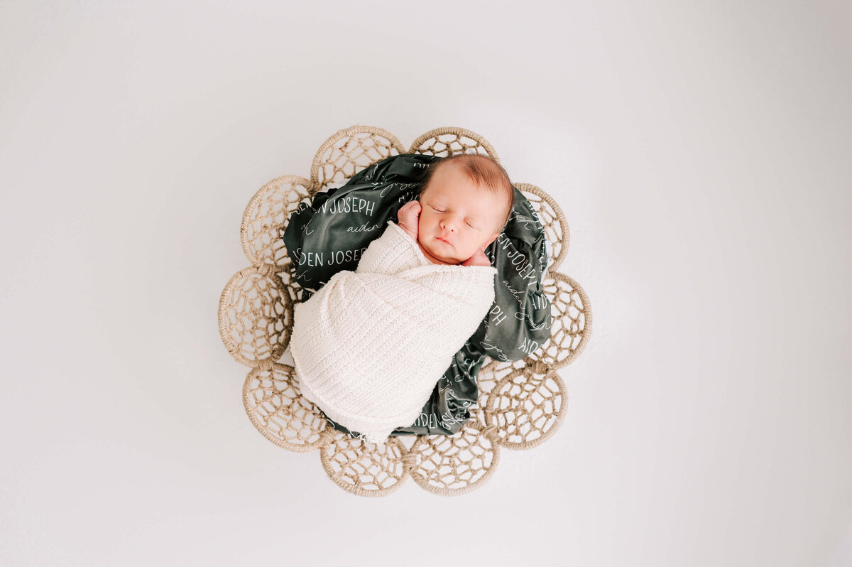 Springfield Mo newborn photography of swaddled newborn sleeping in basket