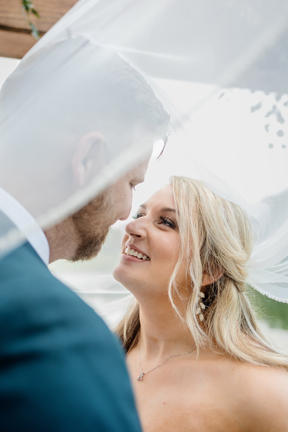 Bride and groom look at each other with love in outdoor ceremony