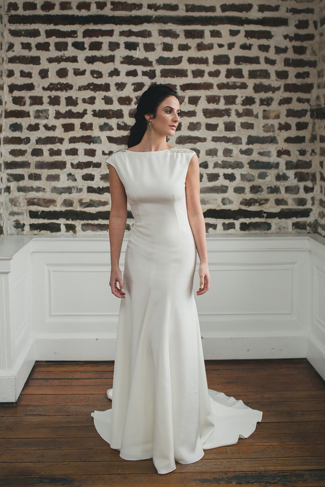 Tamarisk is a crepe wedding gown with a bateau neckline and low back by bridal designer Edith Elan of Charleston, SC.
