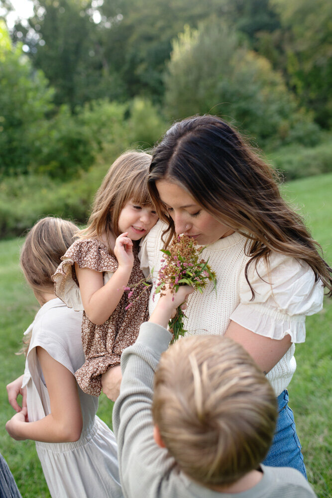 Mother smelling flowers