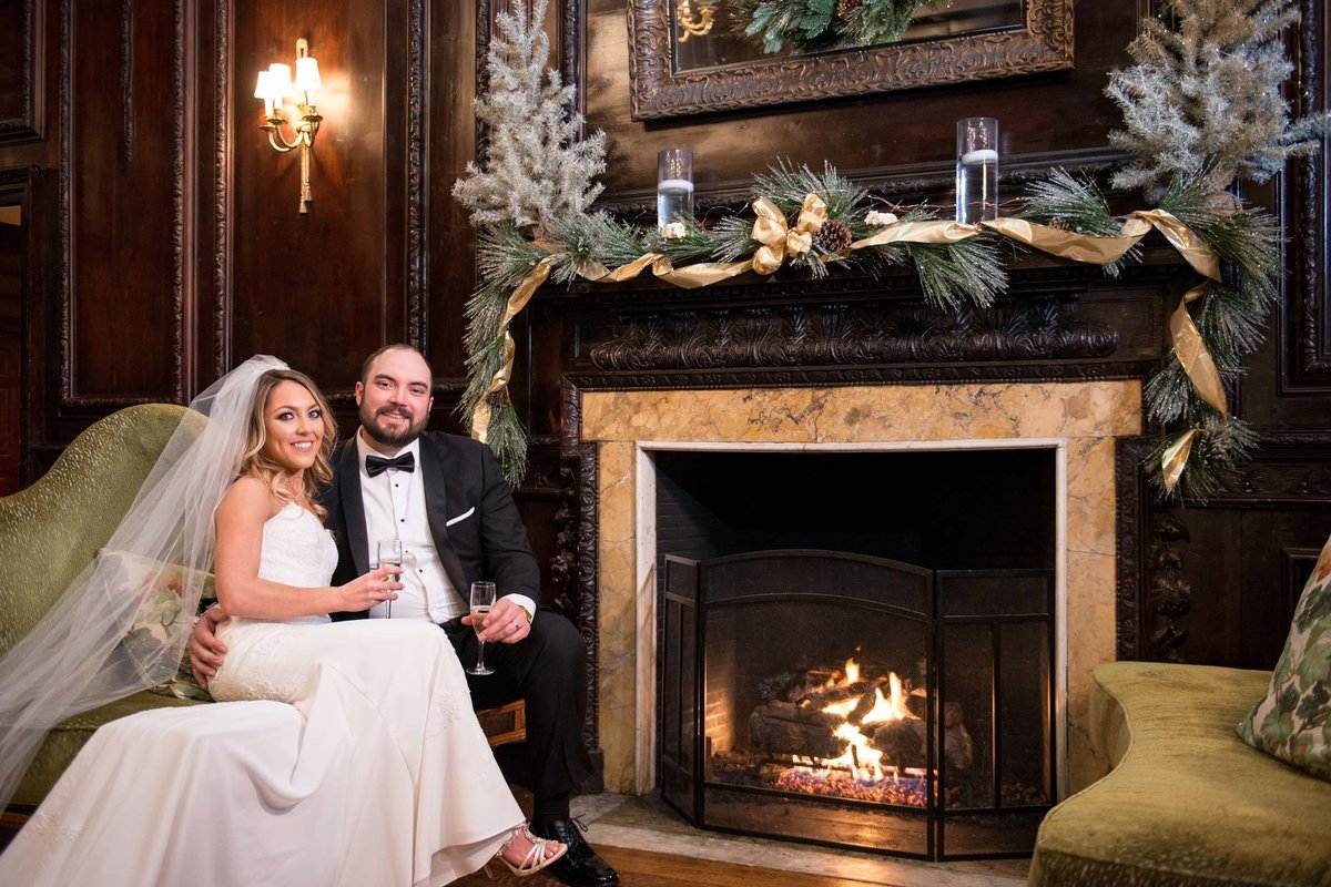 Bride and groom next to the fire place at The Mansion at Oyster Bay