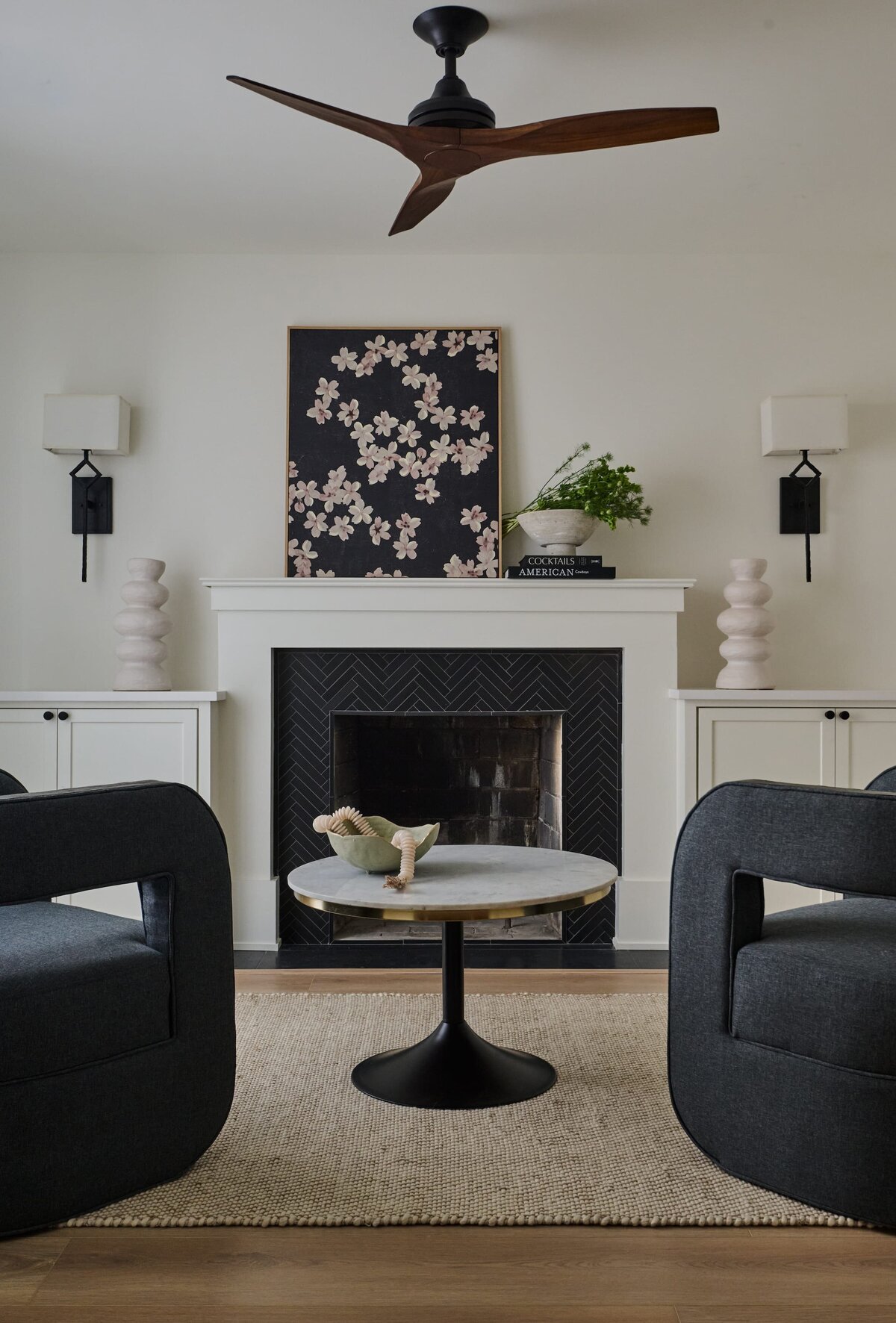 cocoloba homes graham living room with black and whtie fireplace and round table