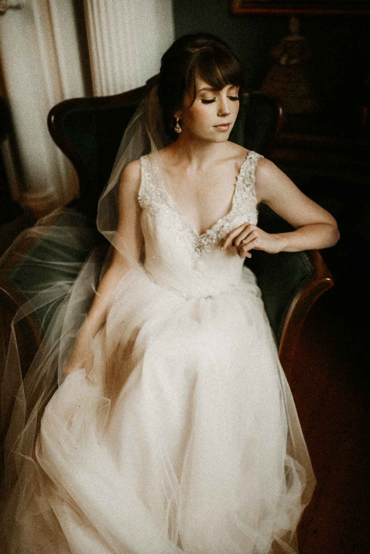 Bride-sitting-in-chair-getting-ready-St-Louis-Missouri-candid-weddings