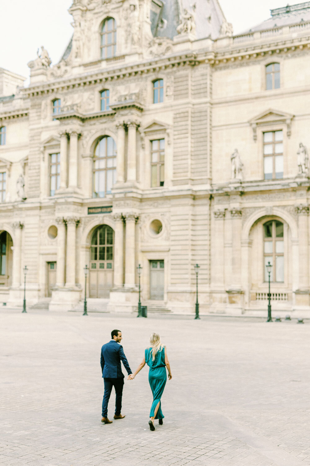 Couple walking in Louver during Paris engagement photography session