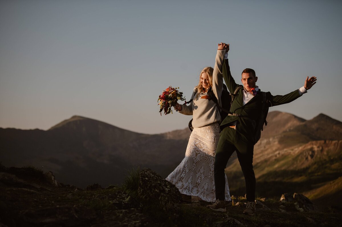 Couple celebrating on top of a mountain