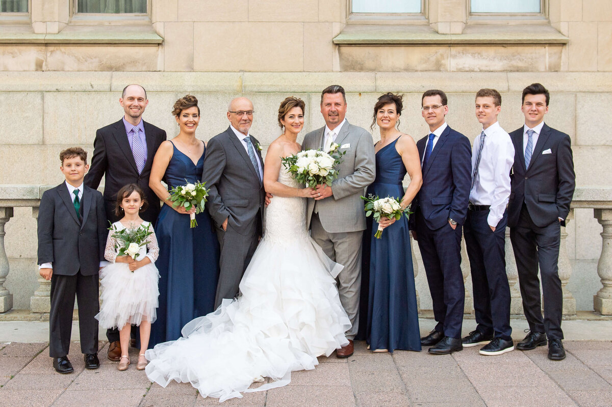 Ottawa wedding photography of an elegant bride and groom with their immediate family on the terrace of the Chateau Laurier hotel