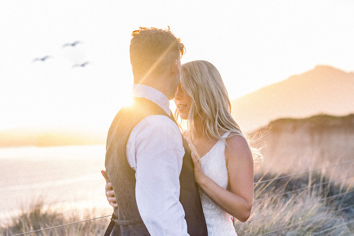 Golden hour on bride and groom at Dolphin Bay Resort in Pismo Beach, CA
