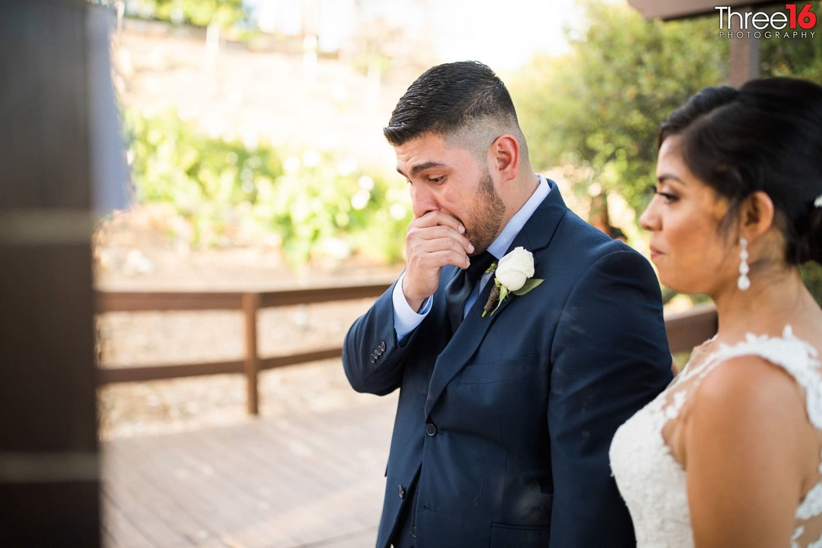 Groom holds back tears during his wedding ceremony