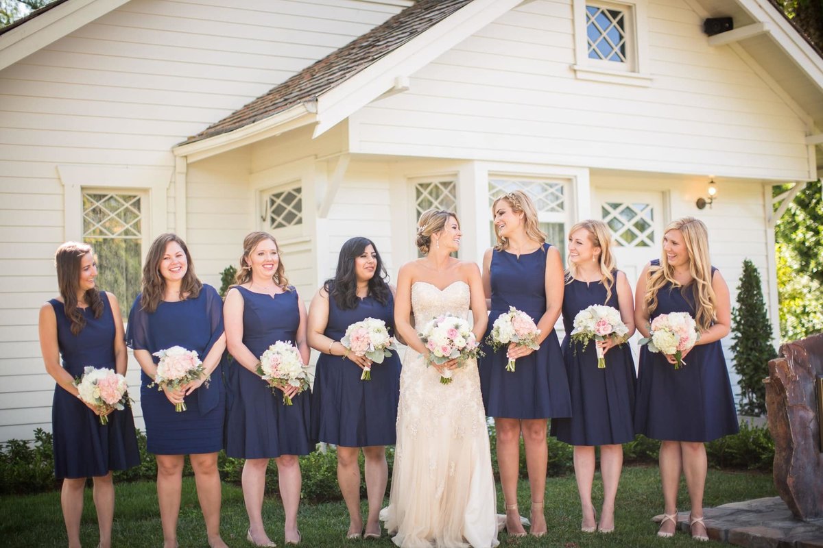 Navy Blue dressed Bridesmaids pose with the Bride in front of Richard Nixon's birth home