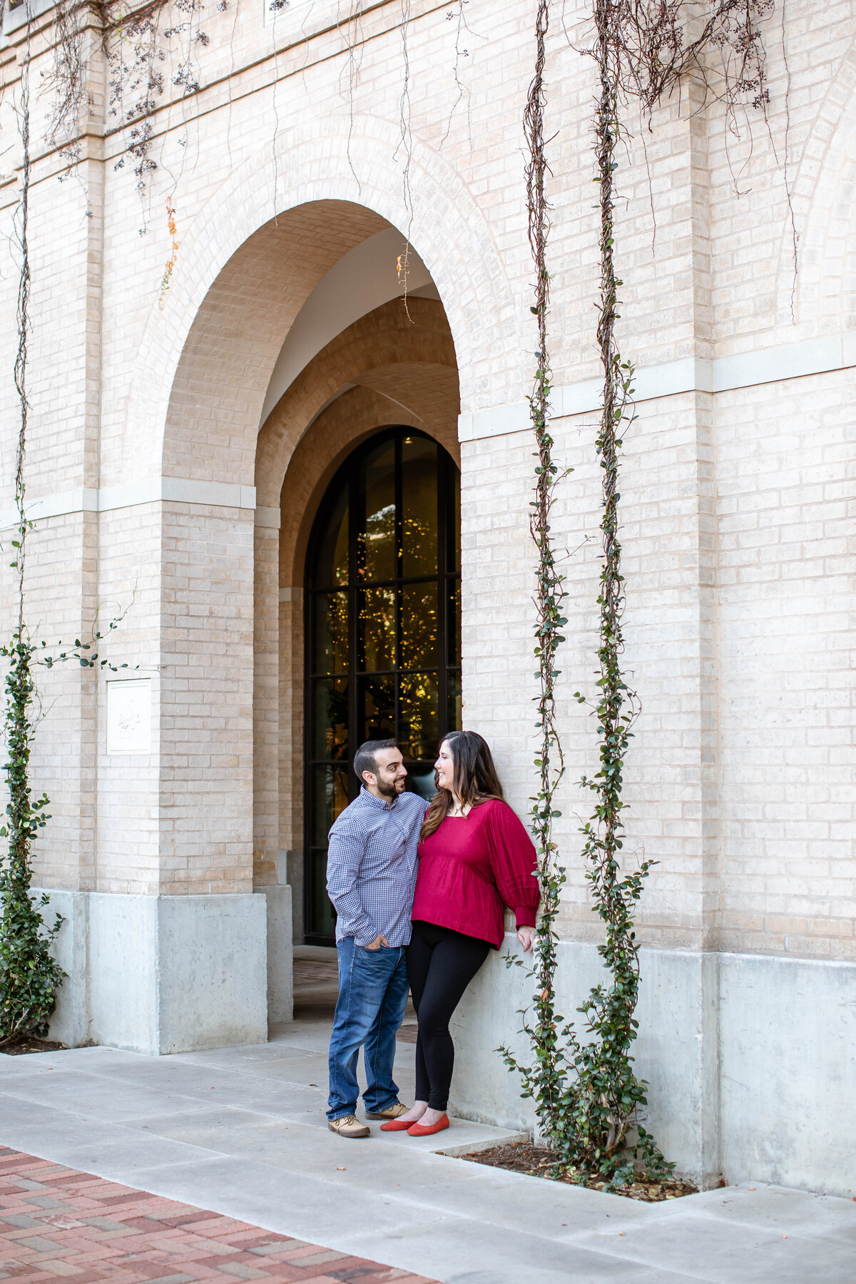 wedding engagement session under arch at The Pearl in San Antonio Texas  by Firefly Photography