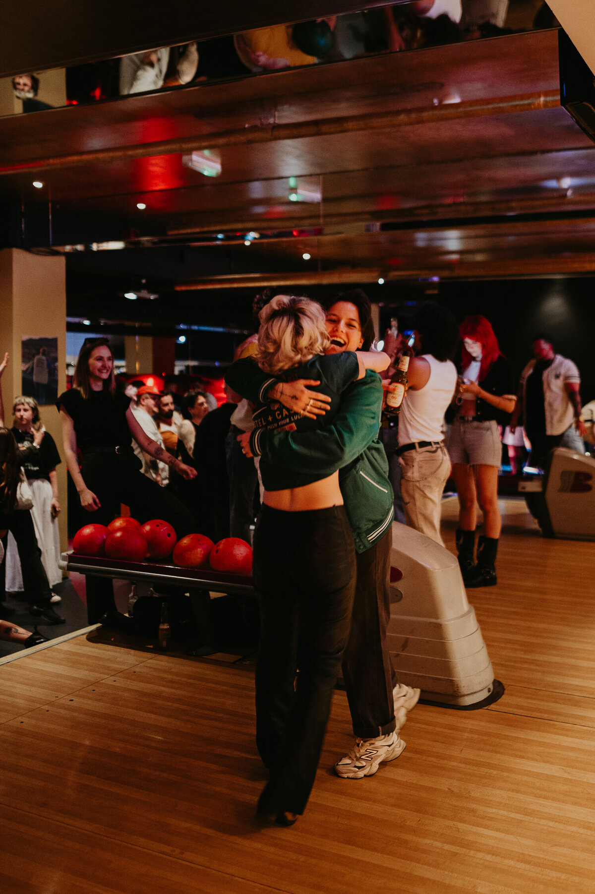 Two bowlers hugging.