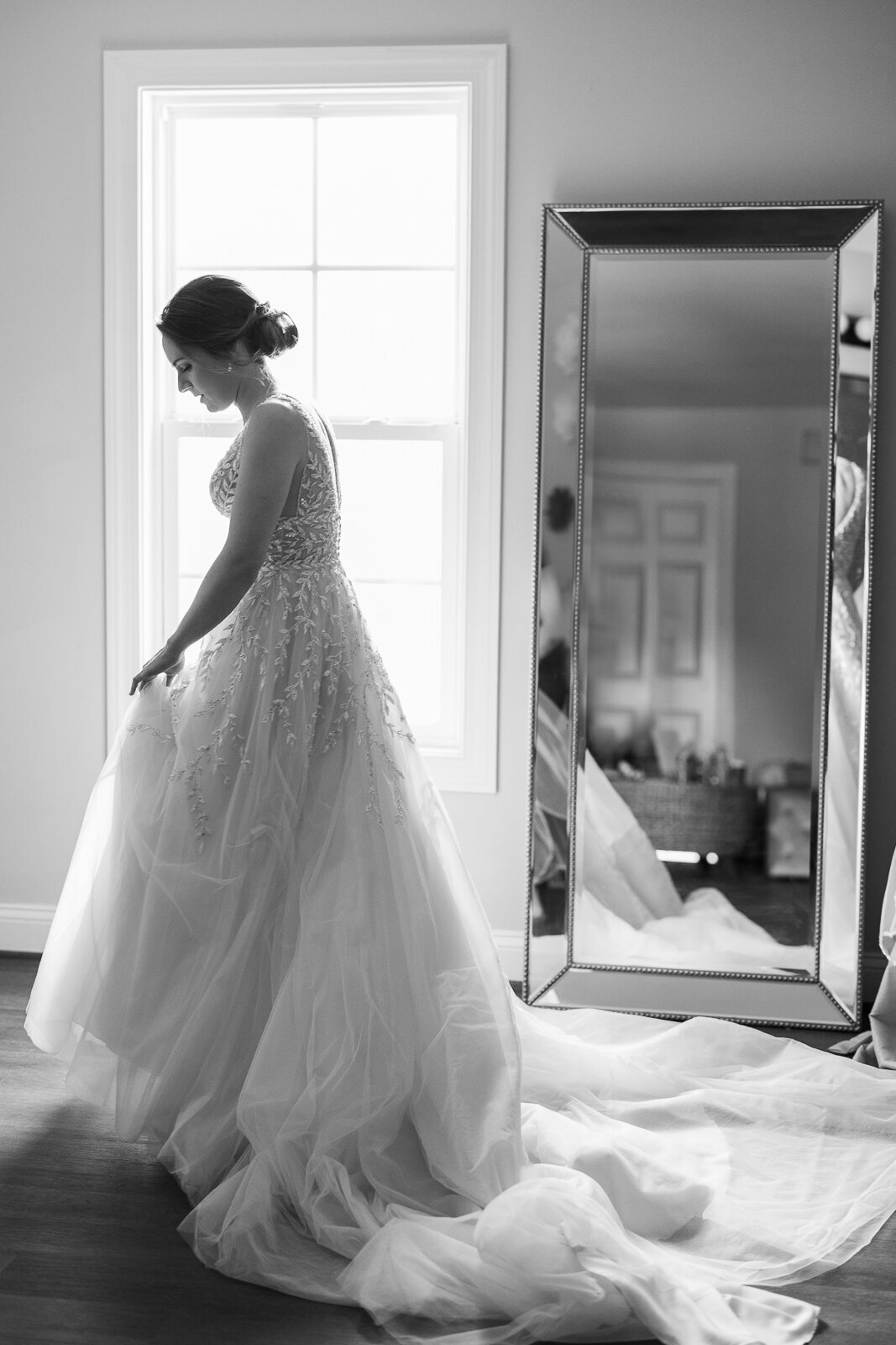 Wedding Photographer, a bride is all dressed up standing and waiting in a n empty bedroom
