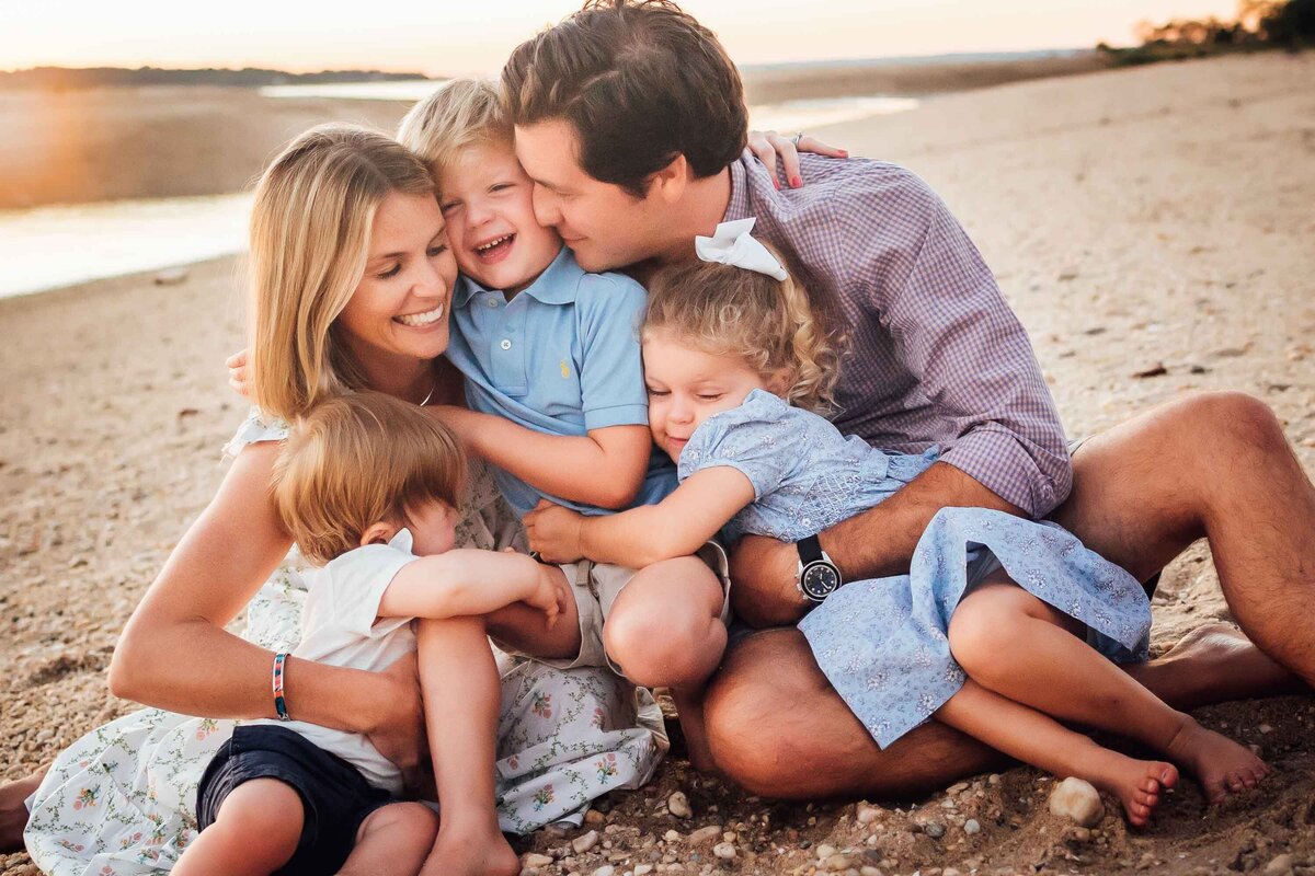 family laughing during long island family photo session on beach