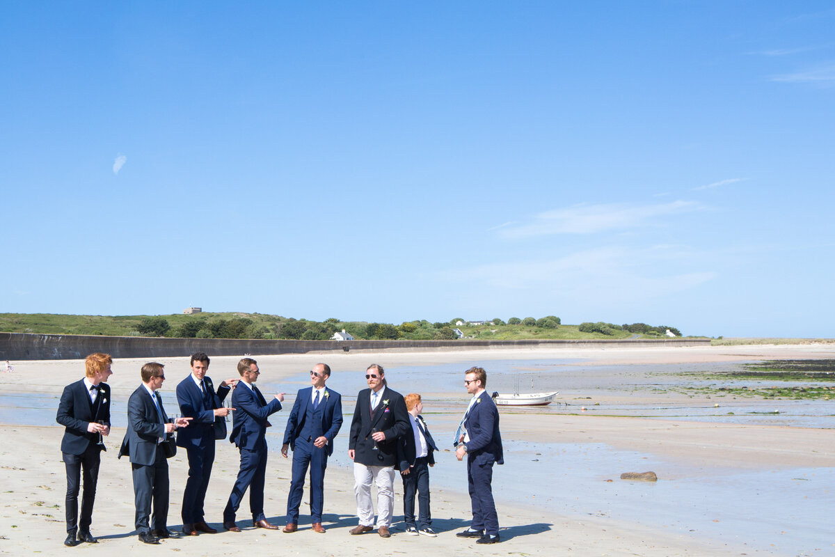 Groomsmen getting ready for ceremony on beach