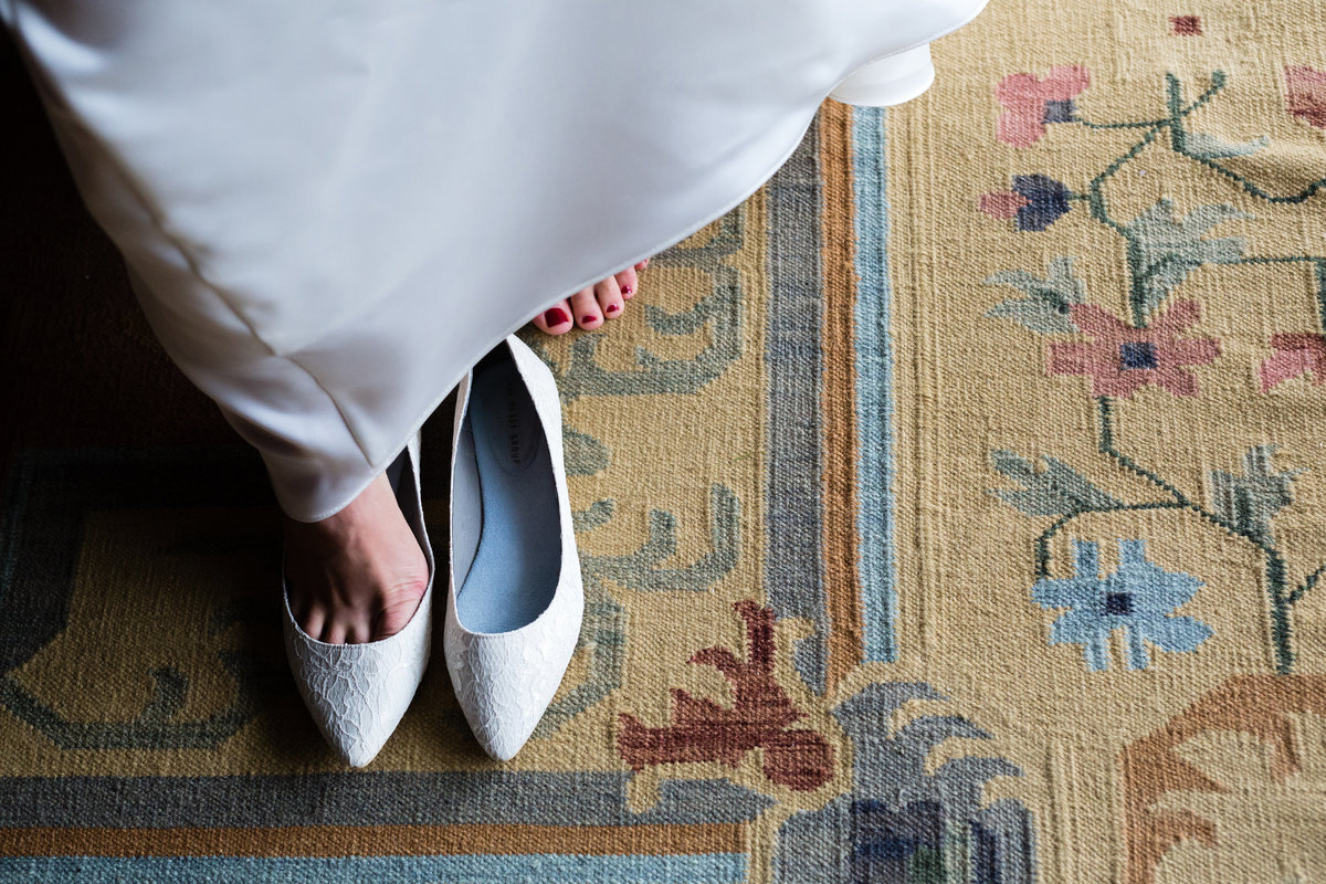 The bride gets into her wedding day shoes at Clarks Cove Farm in Maine