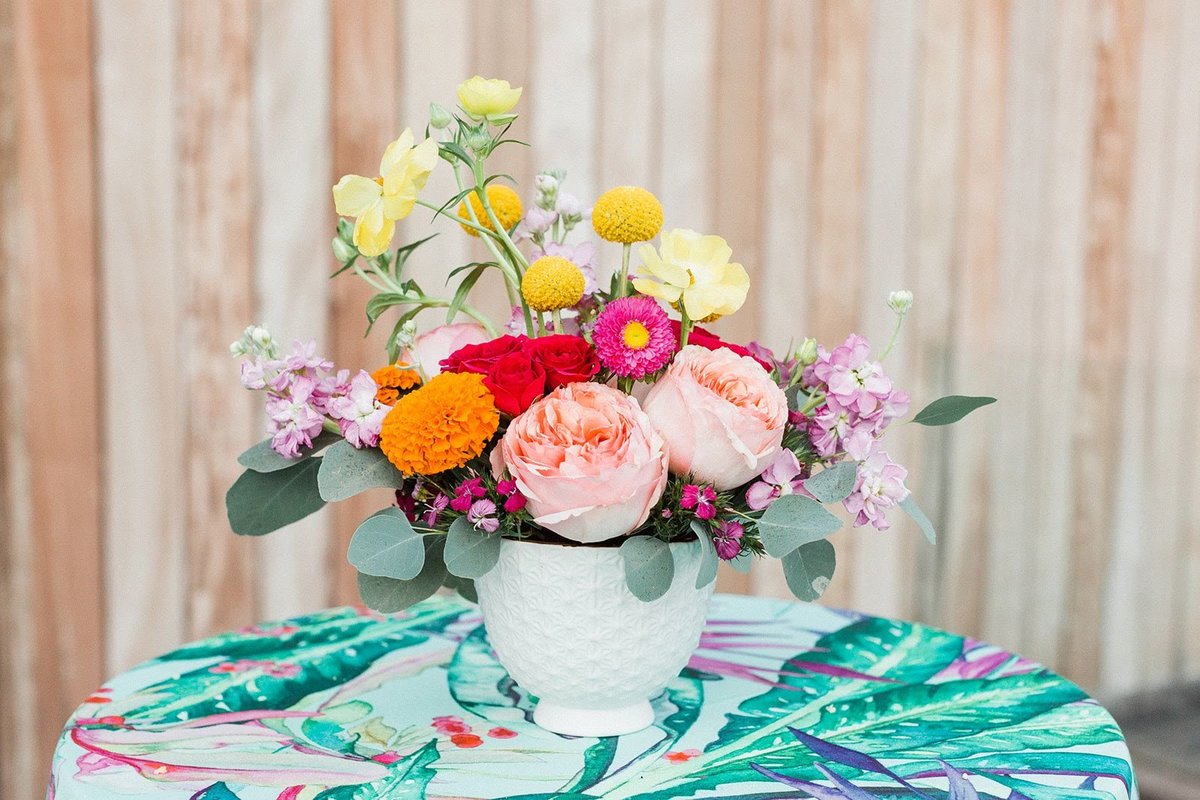 Bright floral centerpiece with tropical linen