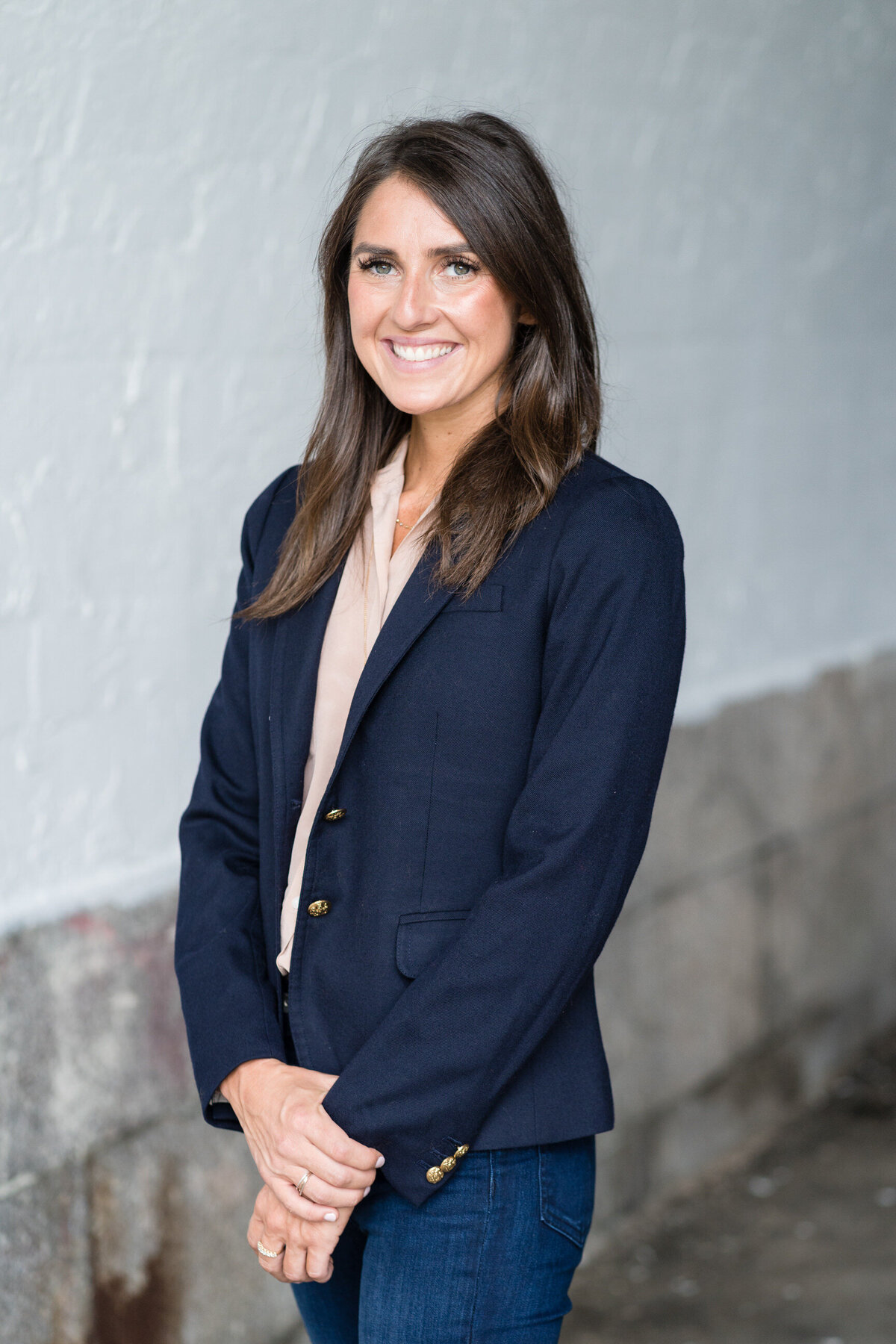 woman in a business jacket smiling