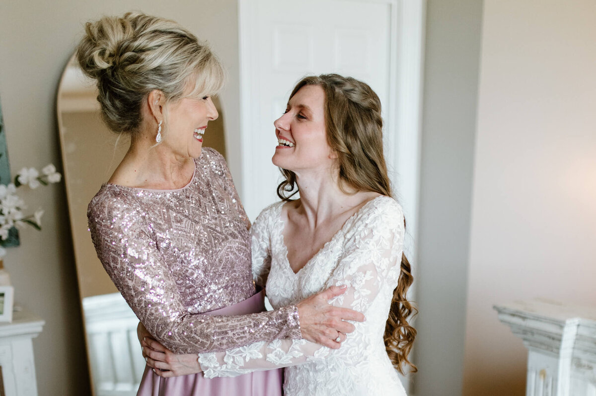 Candid moment between mother of bride and bride just before East TX wedding ceremony