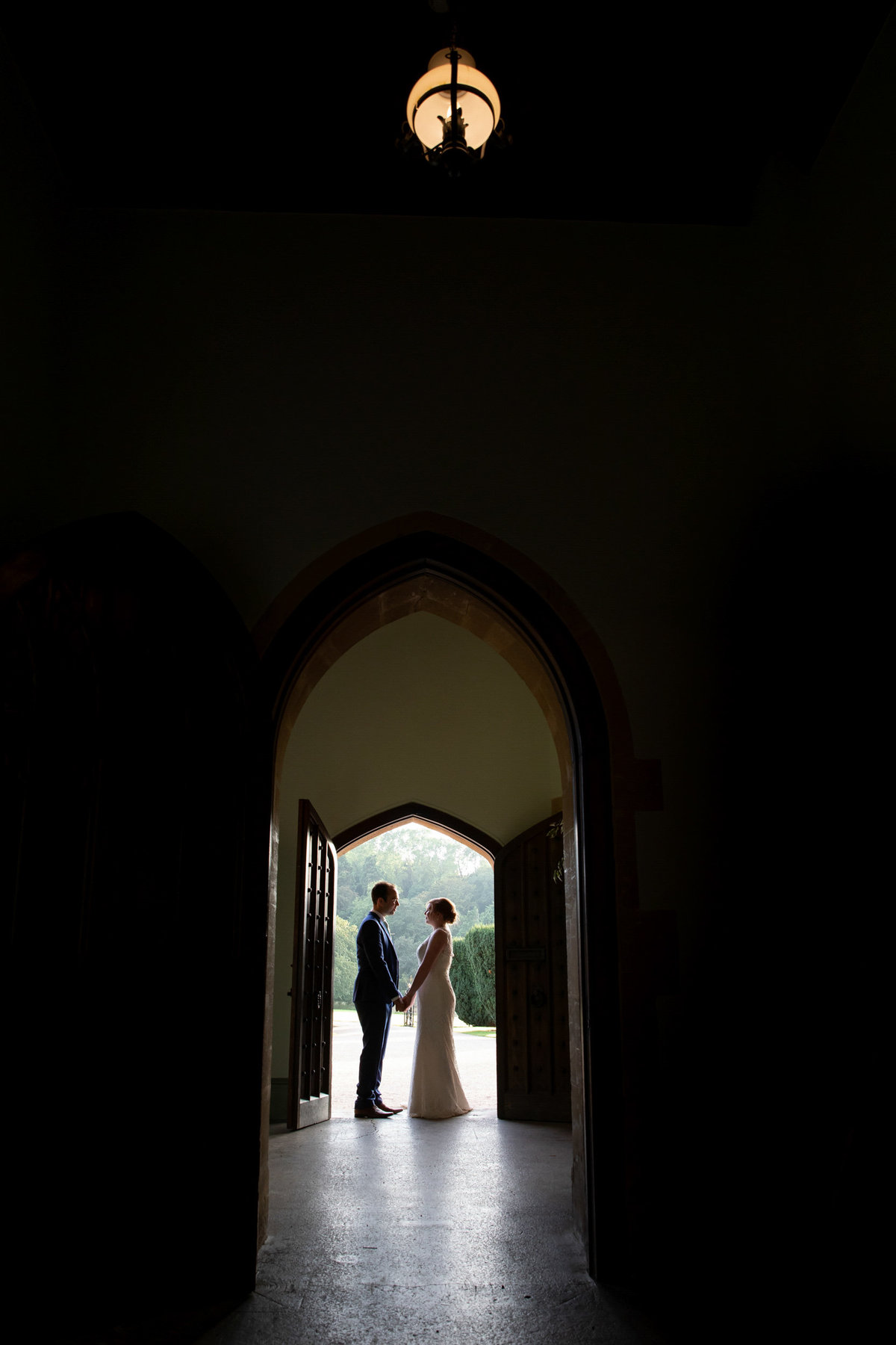 Wedding couple stood in the doorway at St Audries Park Wedding Venue in Somerset