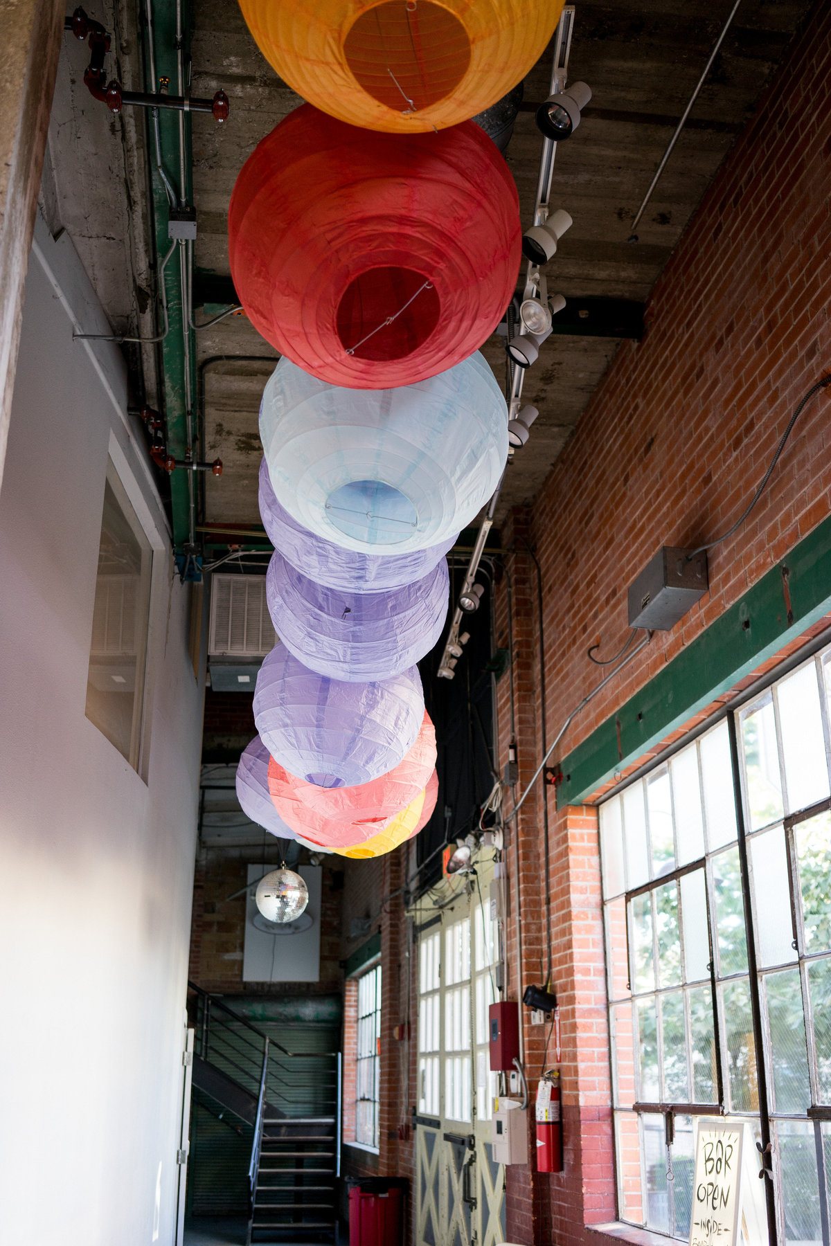 colorful rice paper lanterns modern wedding decor for reception and ceremony at Brick at Blue Star downtown San Antonio