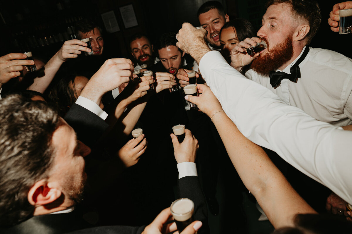 Wedding party do shots at The Stables in Manchester.
