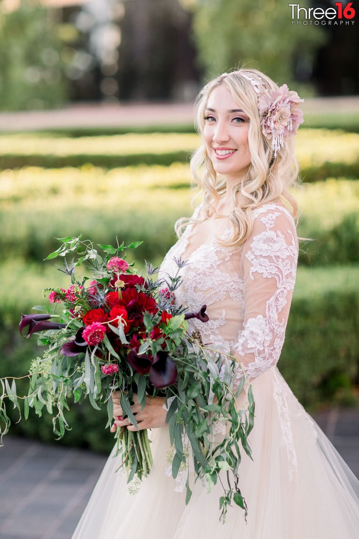 Bride smiles as she poses for the wedding photographer