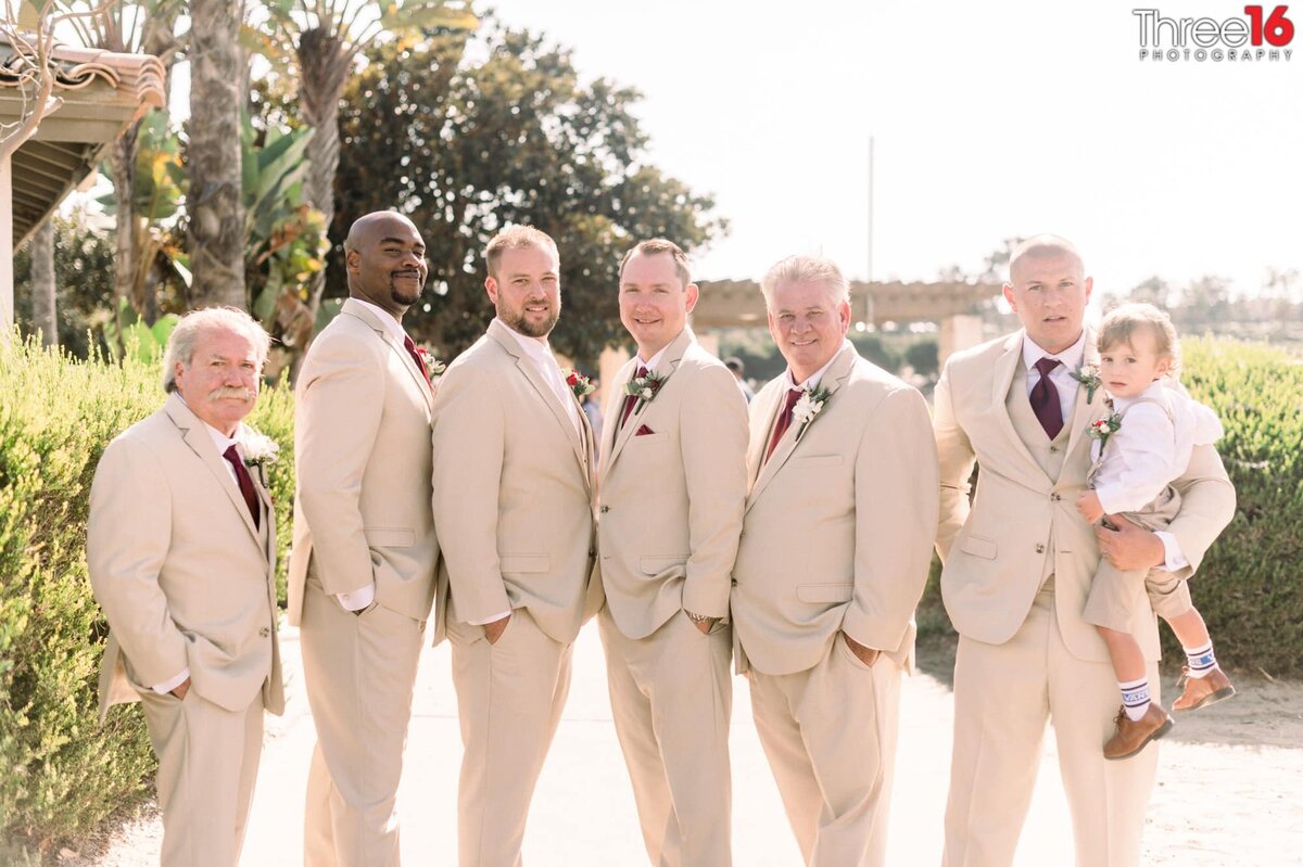 Groom poses with his groomsmen before the wedding ceremony