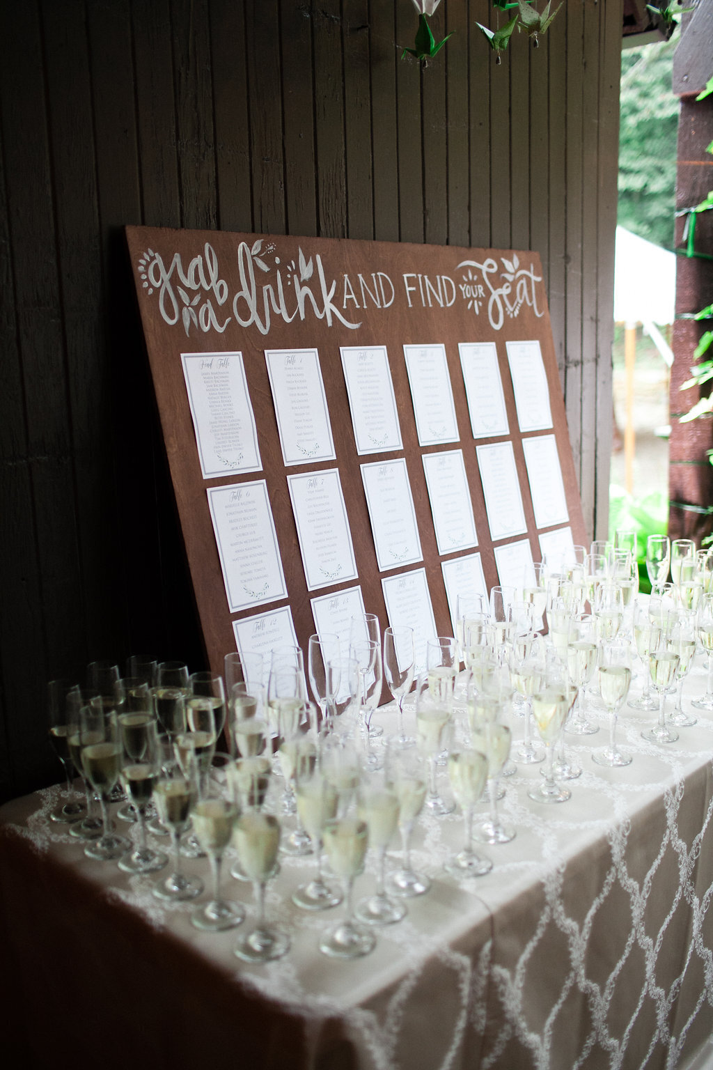Seating chart with champagne flutes at a private estate wedding in Minnesota
