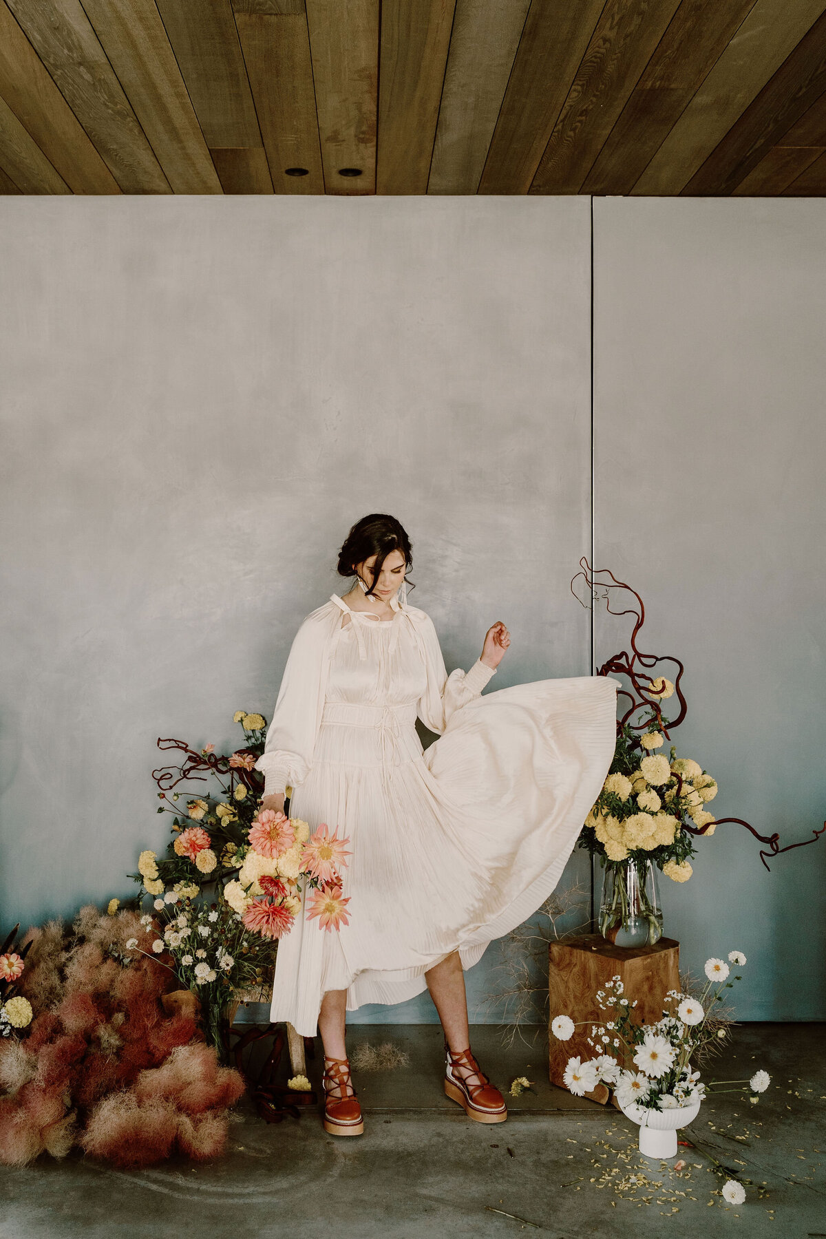 The Lovers Elopement Co - bride poses with floral arrangements