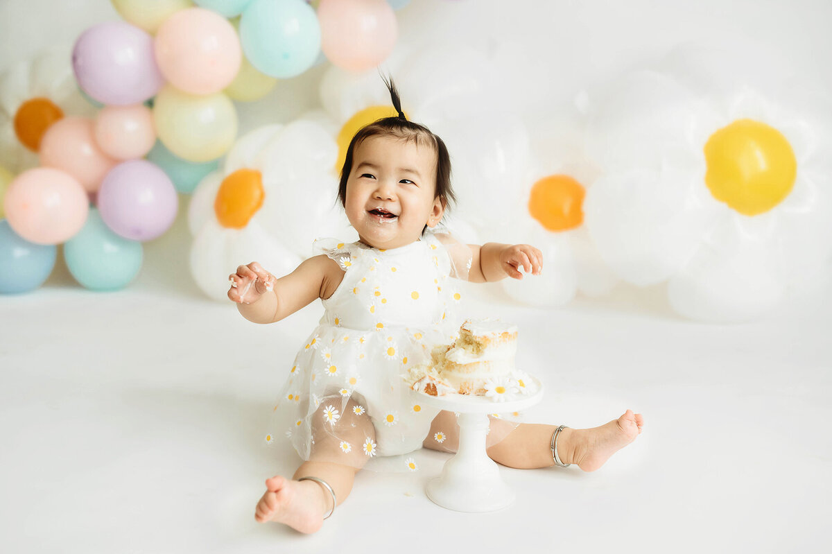 Baby laughs during Cake Smash Photoshoot in Asheville, NC.