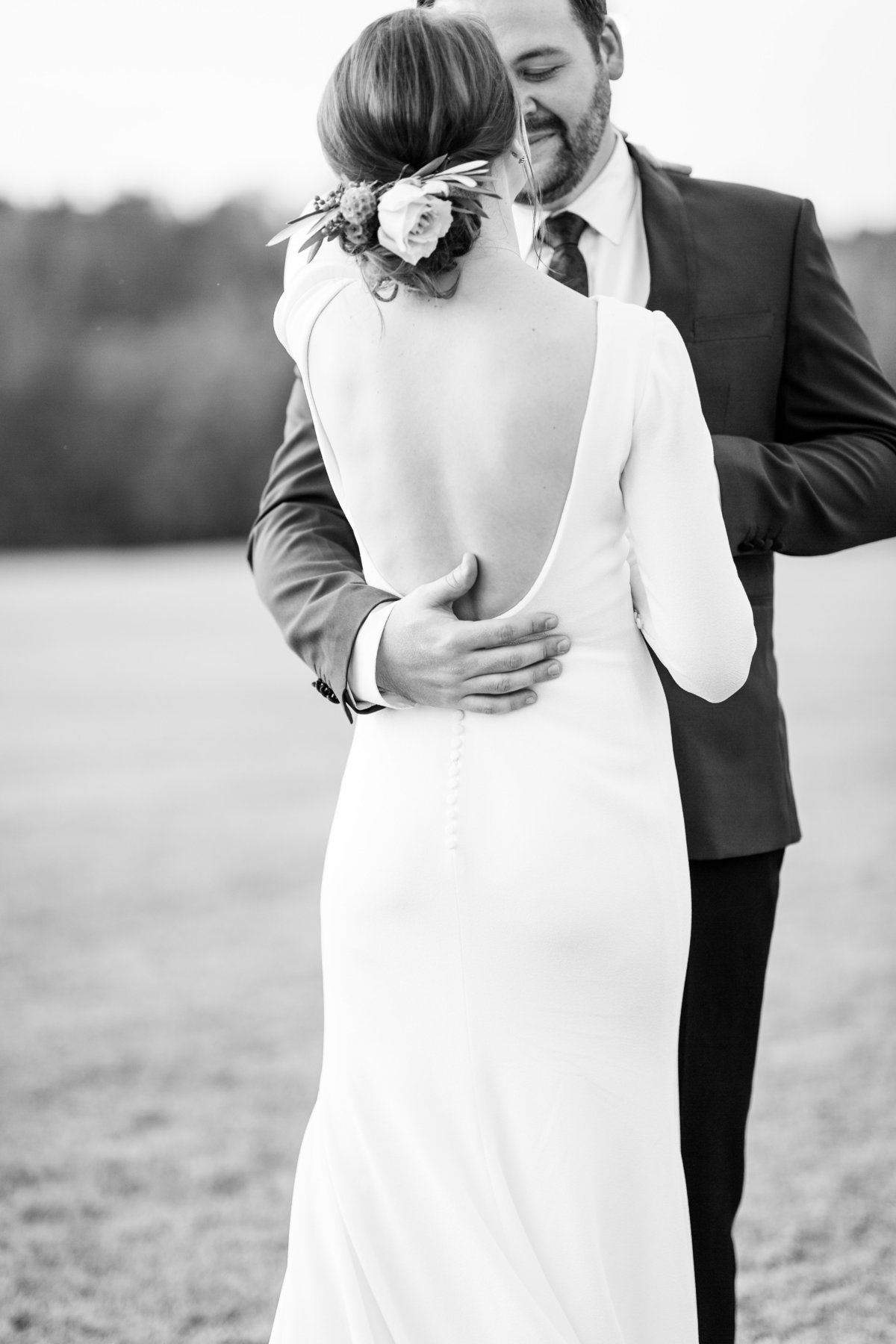 bride and groom embracing in black and white
