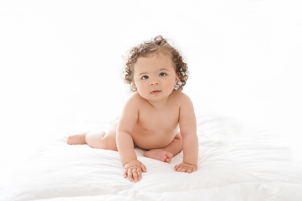 Baby and child photographer in Chandler, AZ baby girl sitting on white blanket