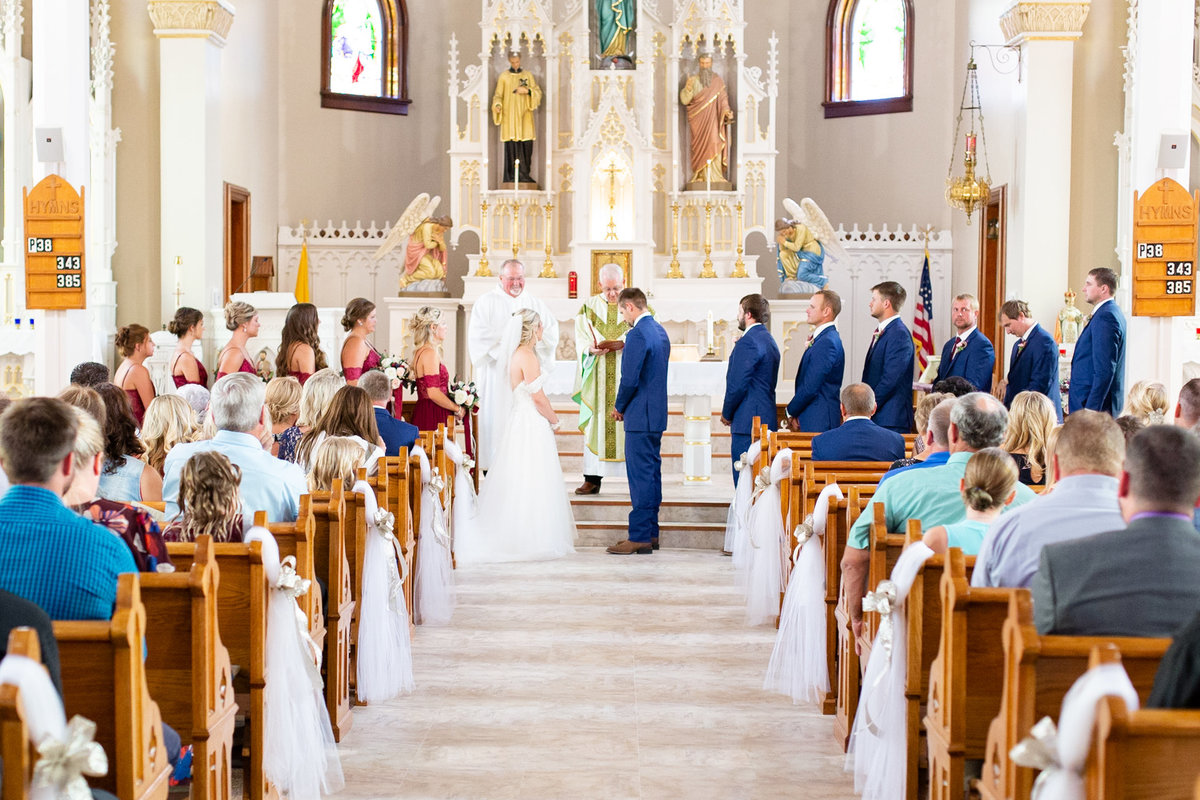 Bride and groom exchange wedding vows at Immaculate Conception