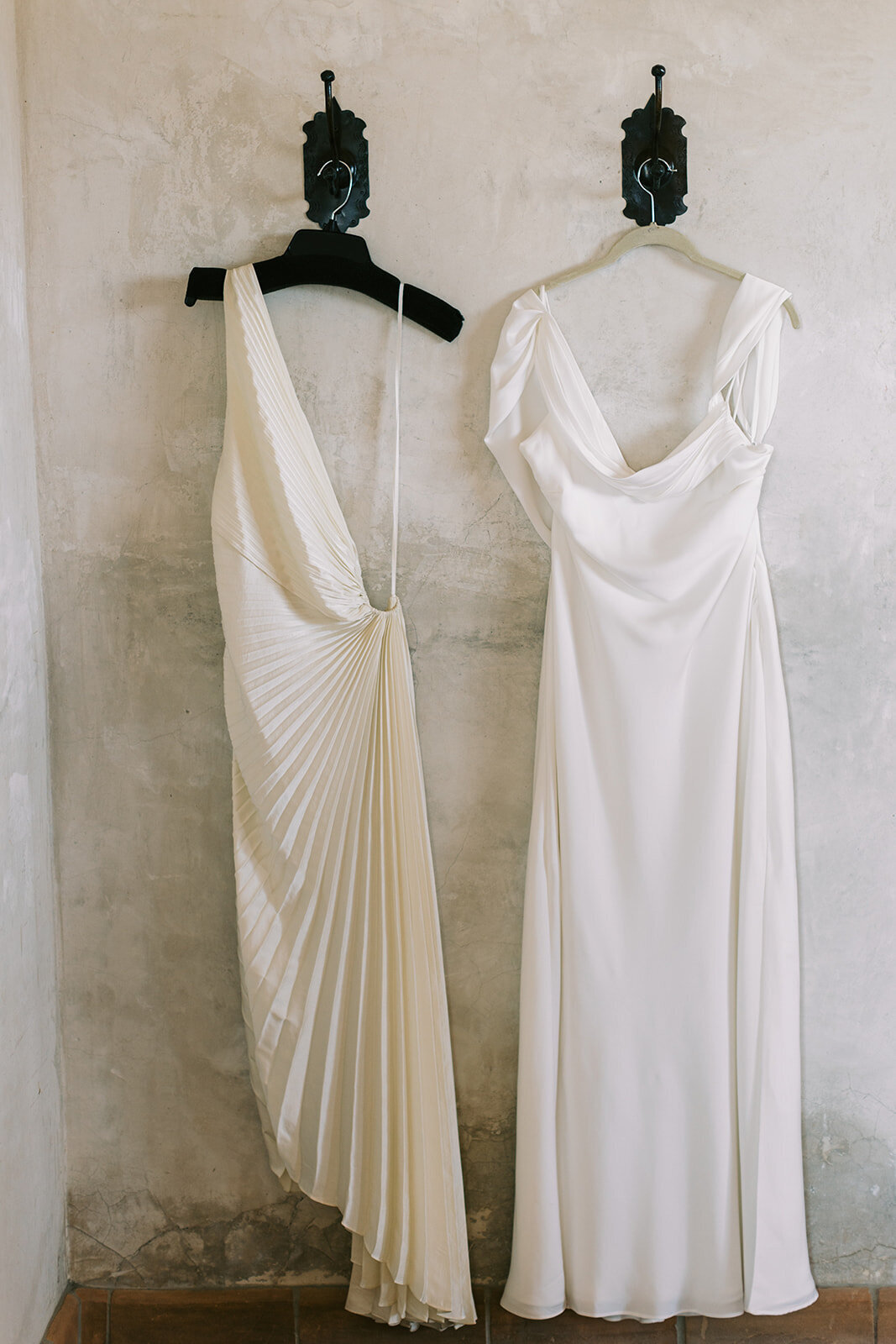 wedding gown and reception dress for bride hanging in bridal suite